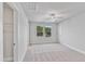 Bright, carpeted bedroom featuring a ceiling fan, two windows, and a walk-in closet at 757 Portland Rose Dr, Knightdale, NC 27545