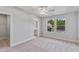 This sunlit bedroom offers neutral carpeting, a ceiling fan, and an ensuite bathroom at 757 Portland Rose Dr, Knightdale, NC 27545