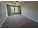 Spacious bedroom featuring plush carpeting, natural lighting, and a ceiling fan at 757 Portland Rose Dr, Knightdale, NC 27545