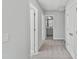 Upstairs hallway with carpet and neutral paint leading to bedrooms and bathrooms at 757 Portland Rose Dr, Knightdale, NC 27545