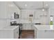 Modern kitchen features white cabinets, subway tile backsplash, stainless steel appliances and hardwood flooring at 757 Portland Rose Dr, Knightdale, NC 27545