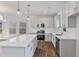 Modern kitchen featuring stainless steel appliances, a large island, and stylish pendant lighting at 757 Portland Rose Dr, Knightdale, NC 27545