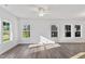 Bright living room featuring hardwood floors and ample natural light from large windows at 757 Portland Rose Dr, Knightdale, NC 27545
