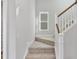 Carpeted staircase with white railing and stained wood handrail at 757 Portland Rose Dr, Knightdale, NC 27545
