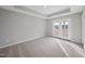 Bright bedroom with carpet flooring and French doors leading to a balcony at 80 Blue Iris Pkwy # 129, Clayton, NC 27520