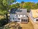 Aerial view of the home's backyard, neighboring houses, and treelined surroundings on a bright day at 113 S Ennis St, Fuquay Varina, NC 27526