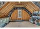 Unfinished attic with insulation, wooden beams, and natural light provides space for customization at 113 S Ennis St, Fuquay Varina, NC 27526
