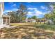 Wide backyard featuring healthy green grass, a patio, and a view of adjacent residential properties at 113 S Ennis St, Fuquay Varina, NC 27526