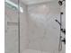 Modern bathroom showcasing luxurious marble tile and sleek, matte black fixtures at 113 S Ennis St, Fuquay Varina, NC 27526