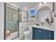 Elegant bathroom featuring a glass shower, navy blue vanity, and sleek fixtures at 113 S Ennis St, Fuquay Varina, NC 27526