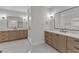 A luxury bathroom with dual vanities, framed mirrors, and a glass shower at 113 S Ennis St, Fuquay Varina, NC 27526