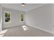 Neutral bedroom with two windows offers a serene and inviting space at 113 S Ennis St, Fuquay Varina, NC 27526
