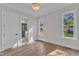 Bright bedroom with natural light, wood floors, crown molding, and an ensuite bathroom at 113 S Ennis St, Fuquay Varina, NC 27526