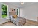 Bright bedroom with natural light, stylish bedding and modern decor create a peaceful retreat at 113 S Ennis St, Fuquay Varina, NC 27526