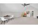 Spacious bonus room with sloped ceiling, fan, and table and chairs, perfect for recreation at 113 S Ennis St, Fuquay Varina, NC 27526