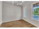Dining room showcasing board and batten walls, hardwood floors, and a sun-filled window at 113 S Ennis St, Fuquay Varina, NC 27526
