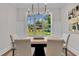 Bright dining room featuring a modern chandelier and a view of the outdoors at 113 S Ennis St, Fuquay Varina, NC 27526