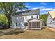 Back exterior of a two story home with a screened in porch in a backyard setting at 113 S Ennis St, Fuquay Varina, NC 27526