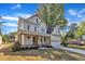 Beautiful two-story white home with a well-manicured lawn and attached two car garage at 113 S Ennis St, Fuquay Varina, NC 27526