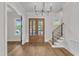 Bright foyer features hardwood floors, iron stair railings, and stylish chandelier at 113 S Ennis St, Fuquay Varina, NC 27526