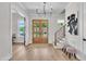 Bright foyer featuring hardwood floors, a modern chandelier, and staircase at 113 S Ennis St, Fuquay Varina, NC 27526