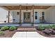 Inviting front porch with rocking chairs, brick steps, and stylish double doors at 113 S Ennis St, Fuquay Varina, NC 27526