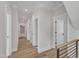 Light-filled hallway with wood floors and access to multiple rooms at 113 S Ennis St, Fuquay Varina, NC 27526