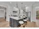 Elegant kitchen featuring white cabinets, a black island, and stainless steel appliances at 113 S Ennis St, Fuquay Varina, NC 27526