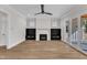 Bright open living room with fireplace, built-in shelves and sliding doors at 113 S Ennis St, Fuquay Varina, NC 27526