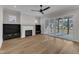 Bright living room with fireplace, built-in shelves, ceiling fan and sliding glass doors to the backyard at 113 S Ennis St, Fuquay Varina, NC 27526
