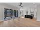 Open floor plan with hardwood floors seamlessly connecting the living area and kitchen at 113 S Ennis St, Fuquay Varina, NC 27526