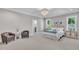 Well-appointed primary bedroom featuring sitting area, neutral palette and ensuite bathroom at 113 S Ennis St, Fuquay Varina, NC 27526