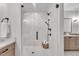 Sleek glass-enclosed shower showcasing modern fixtures, grab bar and pristine white tile at 113 S Ennis St, Fuquay Varina, NC 27526