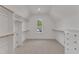 Bright walk-in closet featuring built-in shelving, drawers and natural light at 113 S Ennis St, Fuquay Varina, NC 27526