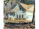 House exterior showcasing a large front porch and stone detailing at 6021 Inverness Cir, Sanford, NC 27332