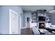 Open living area with fireplace and access to hallway at 6021 Inverness Cir, Sanford, NC 27332