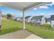 Covered back patio and spacious backyard featuring new sod and a fence surrounding the perimeter of the property at 929 Kinglet House Rd, Knightdale, NC 27545