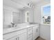 Bright bathroom with double sinks, white cabinets, quartz countertop and natural light from the window at 929 Kinglet House Rd, Knightdale, NC 27545