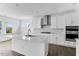 Bright kitchen with a large island, stainless steel hood, built in appliances, and hardwood floors at 929 Kinglet House Rd, Knightdale, NC 27545