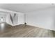 Spacious living room featuring hardwood floors, a staircase, and ample natural light, great for relaxing at 929 Kinglet House Rd, Knightdale, NC 27545