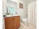 Bathroom featuring a vanity with a white countertop, mirror, toilet, and shower with white tile at 2126 Opulent Oaks Ln # 14, Durham, NC 27713