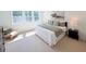 Well-lit bedroom with large windows, a cozy chair, and a comfortable bed at 2126 Opulent Oaks Ln # 14, Durham, NC 27713