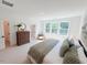 Inviting bedroom featuring a large bed, dresser, and serene decor at 2126 Opulent Oaks Ln # 14, Durham, NC 27713