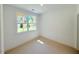 This is an empty bedroom with a large window overlooking a lush backyard at 2126 Opulent Oaks Ln # 14, Durham, NC 27713