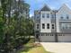 Charming townhome with gray and white siding, large windows, and an attached two-car garage on a sunny day at 2126 Opulent Oaks Ln # 14, Durham, NC 27713