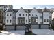 Contemporary townhouses with gray siding, white accents, and attached garages at 2126 Opulent Oaks Ln # 14, Durham, NC 27713