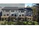 Townhomes with gray siding, white accents, decks, and fenced backyard at 2126 Opulent Oaks Ln # 14, Durham, NC 27713