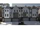 Contemporary townhouses with gray siding, white accents, and attached garages at 2126 Opulent Oaks Ln # 14, Durham, NC 27713