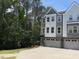 Charming townhome with gray and white siding, large windows, and an attached two-car garage on a sunny day at 2126 Opulent Oaks Ln # 14, Durham, NC 27713