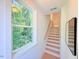 Bright, modern staircase featuring natural light from the nearby window and a view of the bordering woods at 2126 Opulent Oaks Ln # 14, Durham, NC 27713